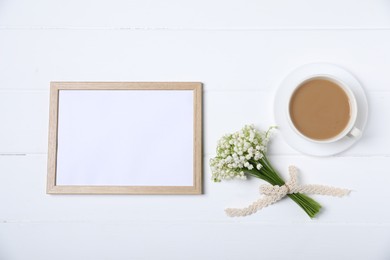Photo of Bouquet of beautiful lily-of-the-valley flowers, coffee and blank frame on white wooden background, flat lay