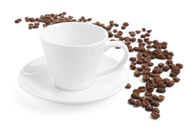 Photo of Ceramic cup with roasted coffee beans isolated on white