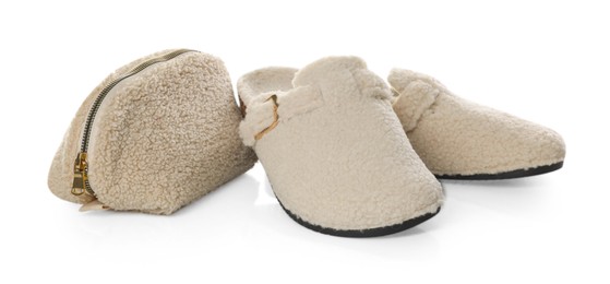 Photo of Stylish slippers and cosmetic bag isolated on white