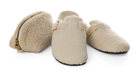 Photo of Stylish slippers and cosmetic bag isolated on white