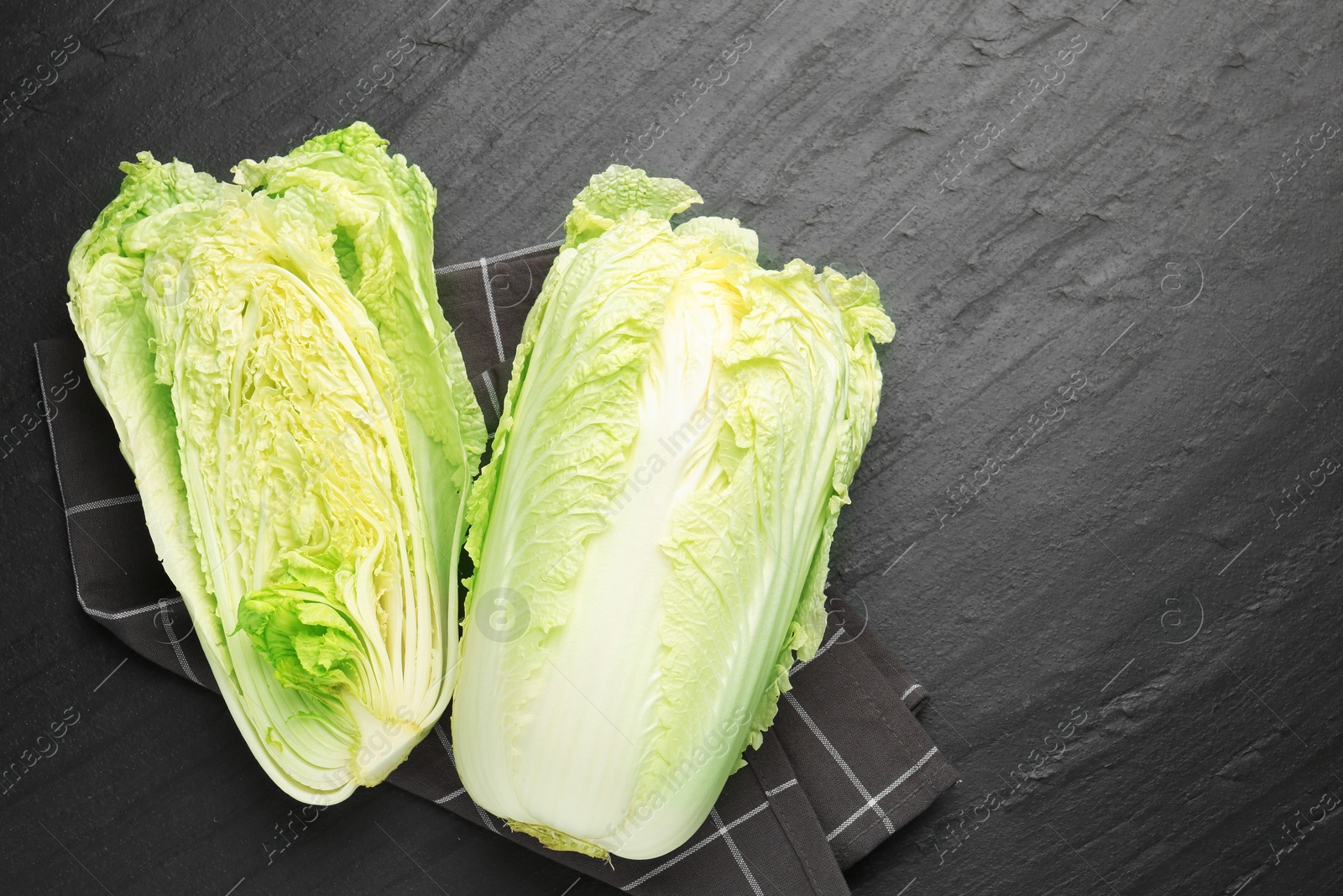 Chinese cabbages on black table, top view. Space for text Photo of Chinese cabbages on black table, top view. Space for text