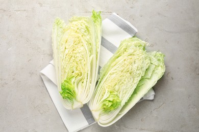 Photo of Cut Chinese cabbage on light grey table, top view