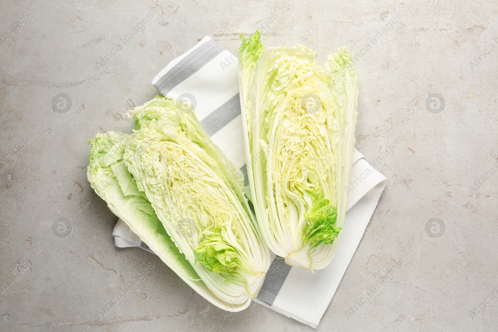 Cut Chinese cabbage on light grey table, top view Photo of Cut Chinese cabbage on light grey table, top view