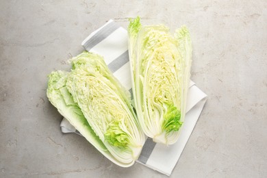 Photo of Cut Chinese cabbage on light grey table, top view