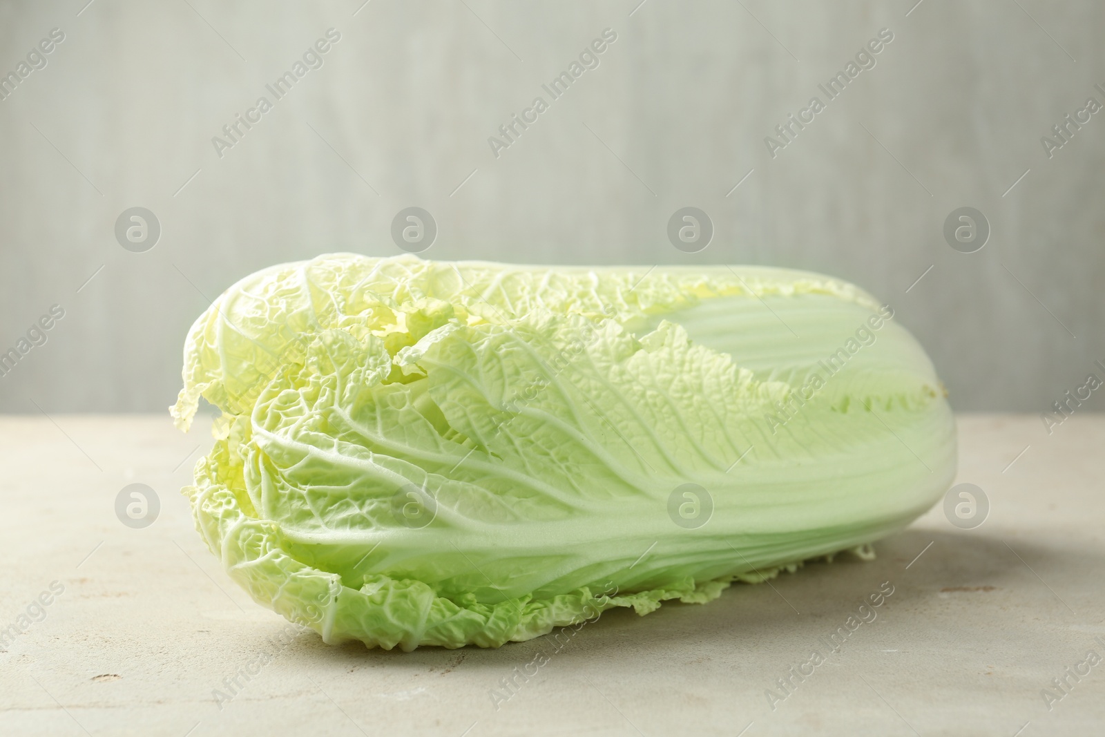 Fresh Chinese cabbage on light grey table, closeup Photo of Fresh Chinese cabbage on light grey table, closeup