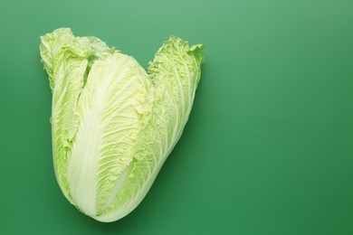 Photo of Fresh Chinese cabbage on green background, top view. Space for text
