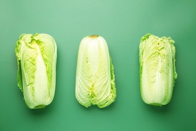 Photo of Fresh Chinese cabbages on green background, flat lay