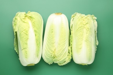 Photo of Fresh Chinese cabbages on green background, flat lay