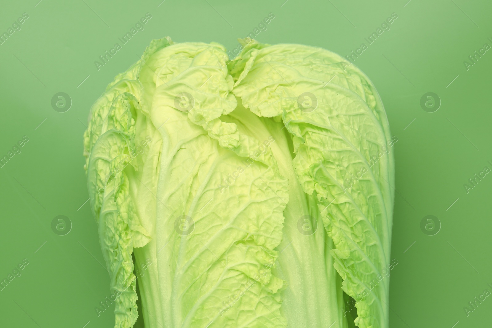 Fresh Chinese cabbage on green background, top view Photo of Fresh Chinese cabbage on green background, top view