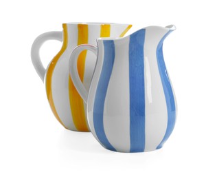 Photo of Two striped ceramic jugs isolated on white