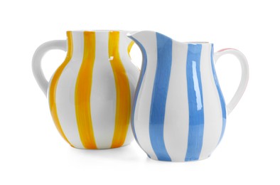 Photo of Two striped ceramic jugs isolated on white