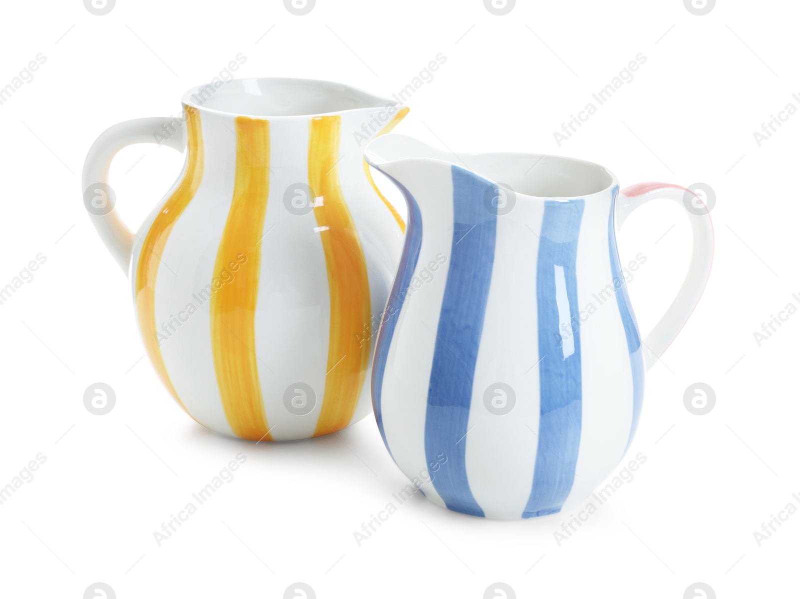 Two striped ceramic jugs isolated on white Photo of Two striped ceramic jugs isolated on white