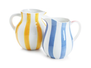 Photo of Two striped ceramic jugs isolated on white