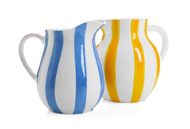 Photo of Two striped ceramic jugs isolated on white