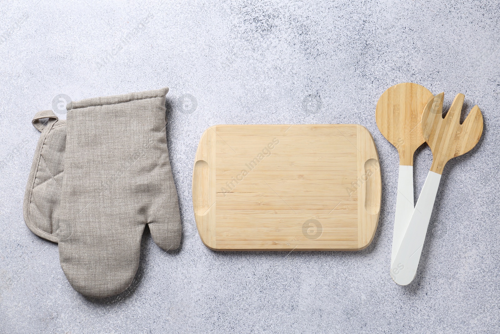 Different kitchen utensils on light table, flat lay Photo of Different kitchen utensils on light table, flat lay