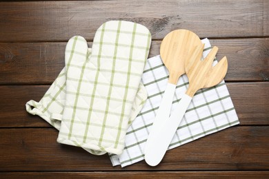 Photo of Different kitchen utensils on wooden table, flat lay
