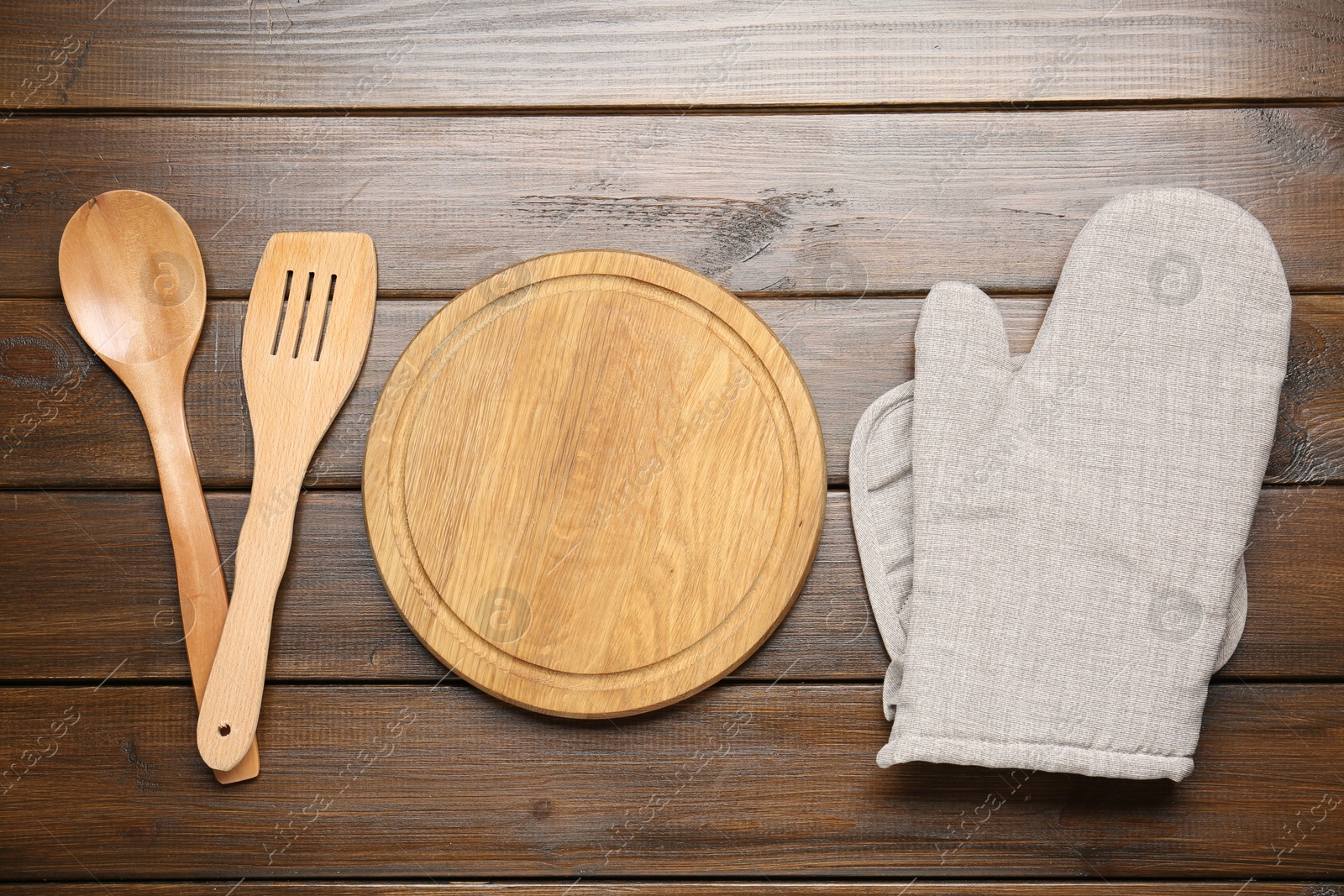Different kitchen utensils on wooden table, flat lay Photo of Different kitchen utensils on wooden table, flat lay