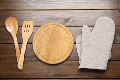 Photo of Different kitchen utensils on wooden table, flat lay