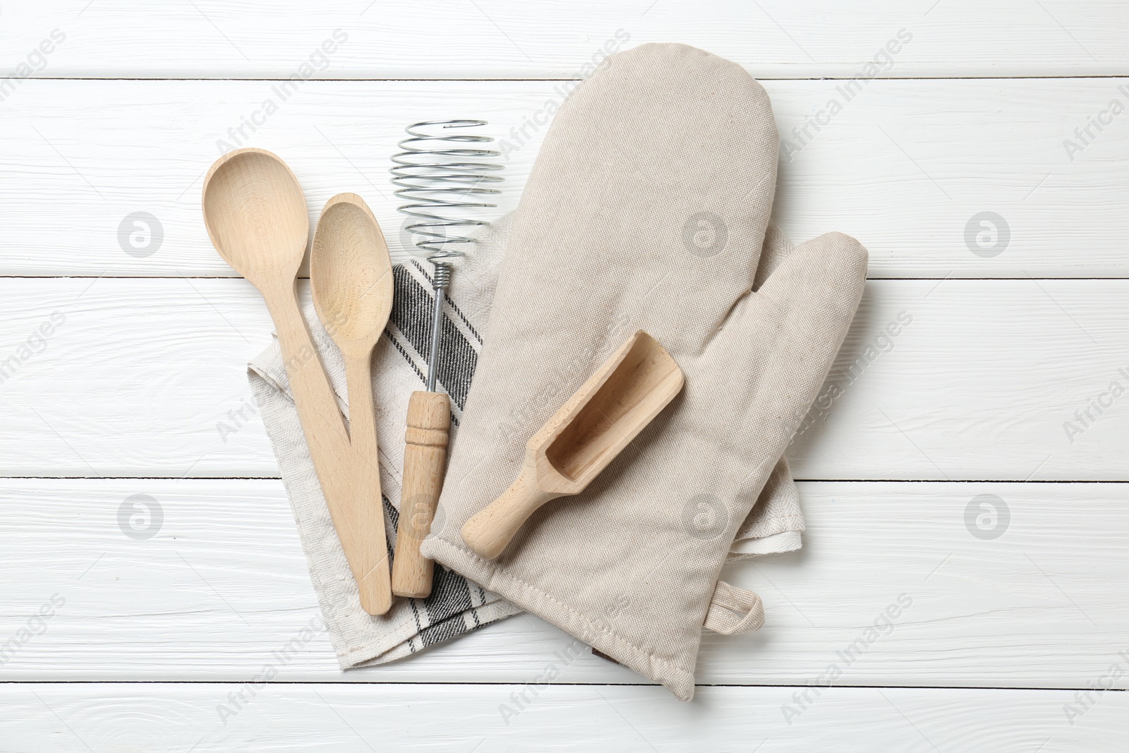 Different kitchen utensils and oven mitten on white wooden table, top view Photo of Different kitchen utensils and oven mitten on white wooden table, top view