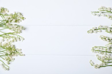 Photo of Beautiful lily-of-the-valley flowers on white wooden background, flat lay. Space for text