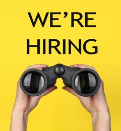 Image of We Are Hiring. Woman with binoculars on yellow background, closeup. Recruitment, human resources concept