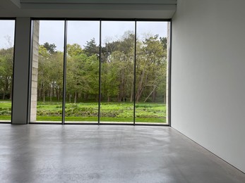 Photo of Empty room with panoramic windows and grey floor