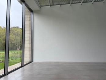 Photo of Empty room with panoramic windows and grey floor