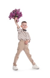 Photo of Little boy with bouquet of lilac flowers on white background