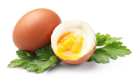 Photo of Soft boiled eggs and parsley on white background