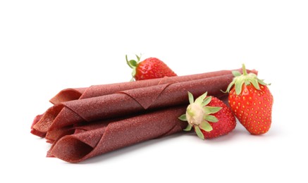 Photo of Tasty fruit leather rolls and strawberries isolated on white