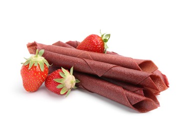 Photo of Tasty fruit leather rolls and strawberries isolated on white