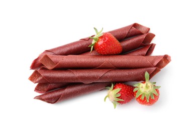 Photo of Tasty fruit leather rolls and strawberries isolated on white, top view
