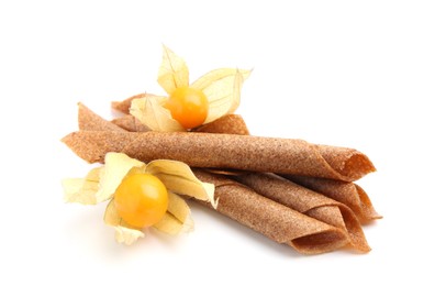 Photo of Tasty fruit leather rolls and physalis isolated on white