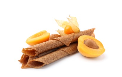 Photo of Tasty fruit leather rolls, apricot and physalis isolated on white