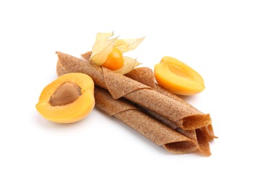 Photo of Tasty fruit leather rolls, apricot and physalis isolated on white