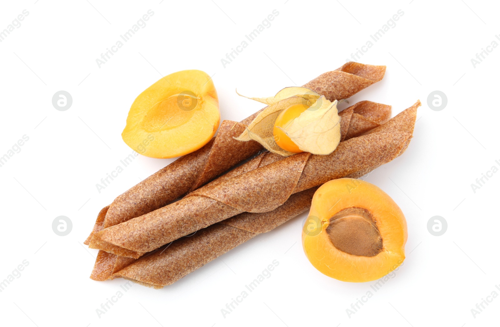 Tasty fruit leather rolls, apricot and physalis isolated on white, top view Photo of Tasty fruit leather rolls, apricot and physalis isolated on white, top view