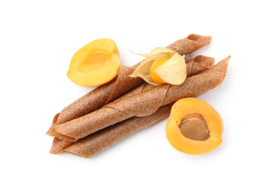 Photo of Tasty fruit leather rolls, apricot and physalis isolated on white, top view