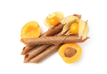 Photo of Tasty fruit leather rolls, apricot and physalis isolated on white, top view