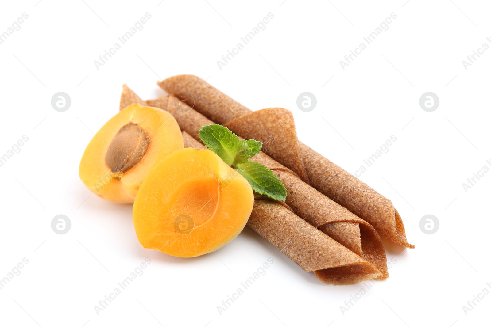 Tasty fruit leather rolls, apricot and mint isolated on white Photo of Tasty fruit leather rolls, apricot and mint isolated on white