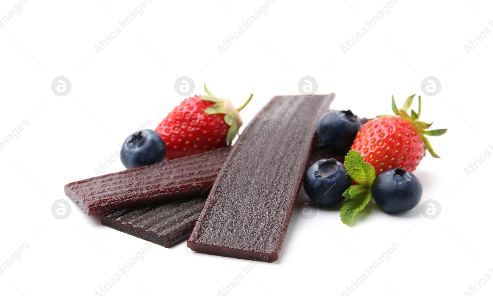 Tasty fruit leather, strawberries and blueberries isolated on white Photo of Tasty fruit leather, strawberries and blueberries isolated on white