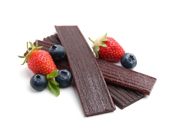 Photo of Tasty fruit leather, strawberries and blueberries isolated on white