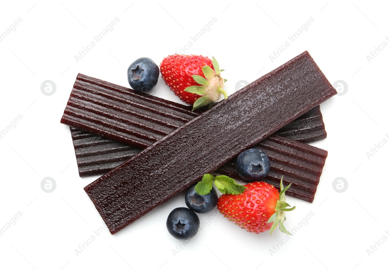 Tasty fruit leather, strawberries and blueberries isolated on white, top view Photo of Tasty fruit leather, strawberries and blueberries isolated on white, top view