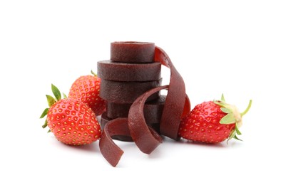 Photo of Tasty fruit leather rolls and strawberries isolated on white