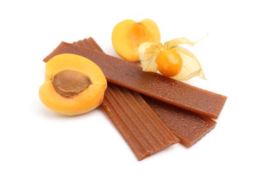 Photo of Tasty fruit leather, apricot and physalis isolated on white