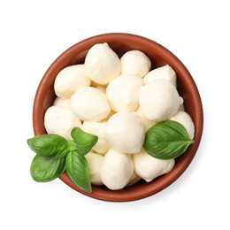 Photo of Tasty mozzarella cheese balls and basil in bowl isolated on white, top view