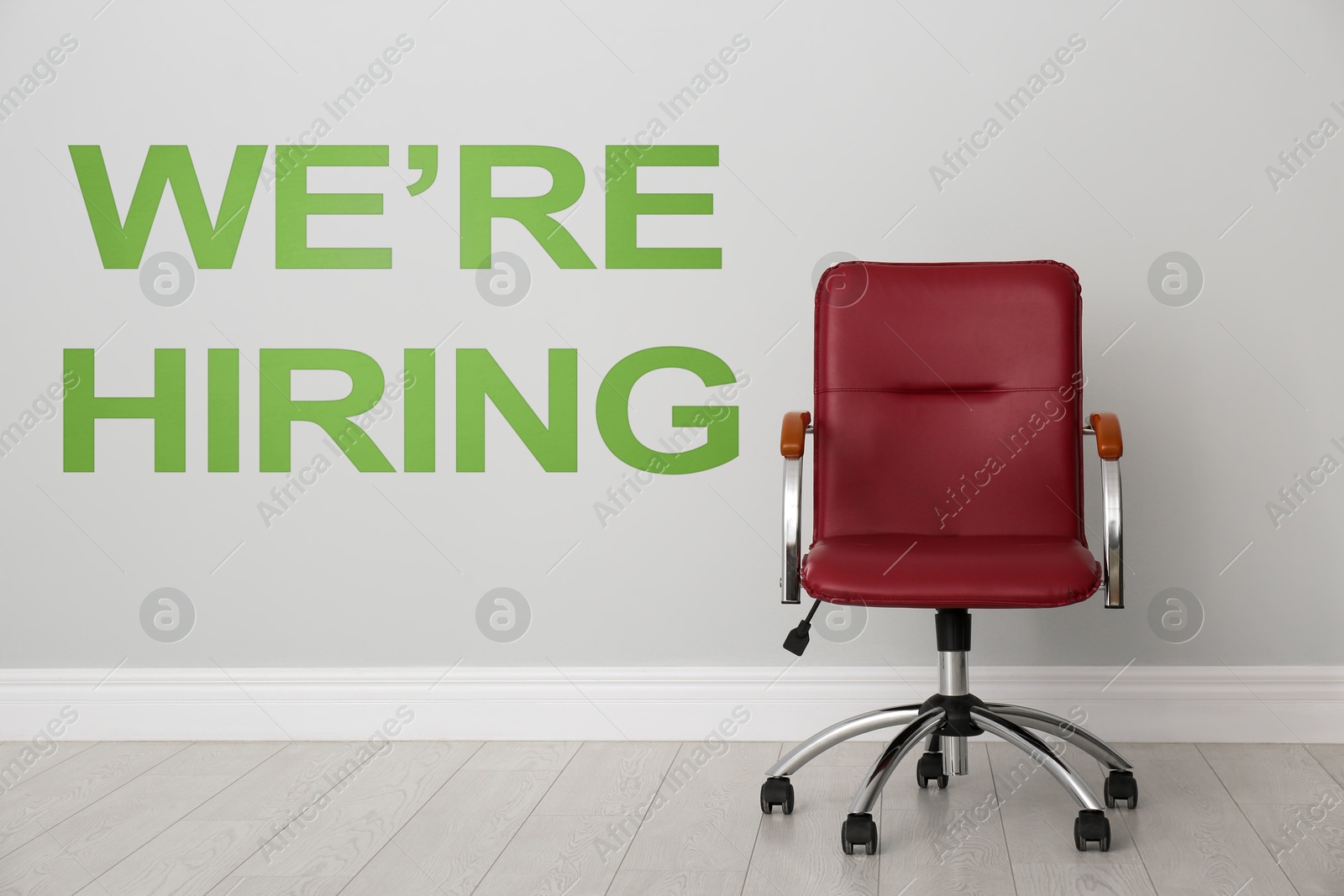 We Are Hiring. Empty office chair near light wall. Recruitment, human resources concept Image of We Are Hiring. Empty office chair near light wall. Recruitment, human resources concept