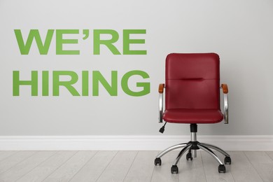 Image of We Are Hiring. Empty office chair near light wall. Recruitment, human resources concept