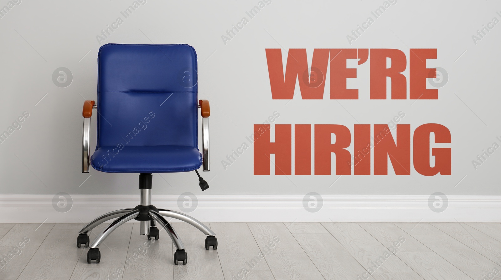 We Are Hiring. Empty office chair near light wall, banner. Recruitment, human resources concept Image of We Are Hiring. Empty office chair near light wall, banner. Recruitment, human resources concept