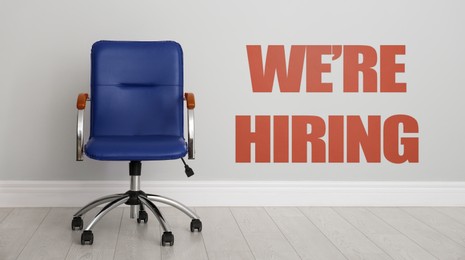 Image of We Are Hiring. Empty office chair near light wall, banner. Recruitment, human resources concept