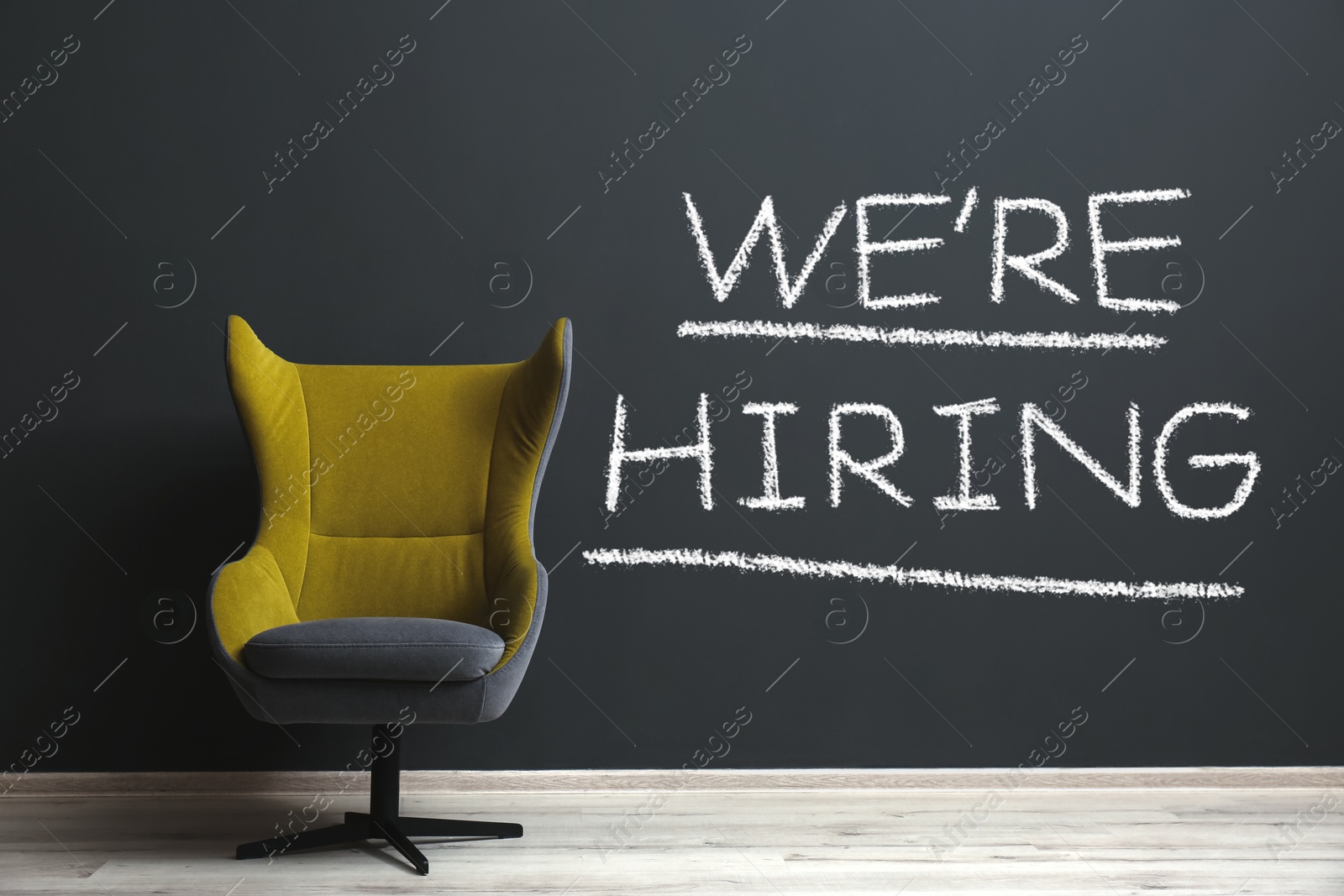 We Are Hiring. Empty office chair near dark wall. Recruitment, human resources concept Image of We Are Hiring. Empty office chair near dark wall. Recruitment, human resources concept
